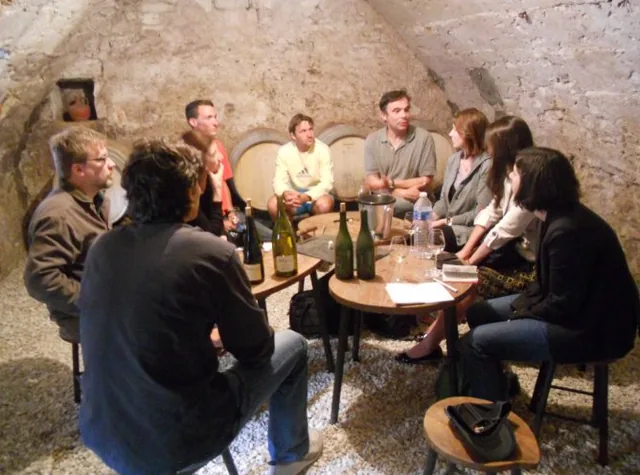 Visitors tasting in a vaulted cellar during a visit to Domaine Delaporte, Chavignol